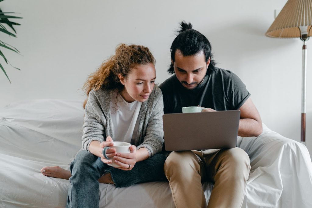 Husband and wife reading an article on the computer about common estate planning questions.