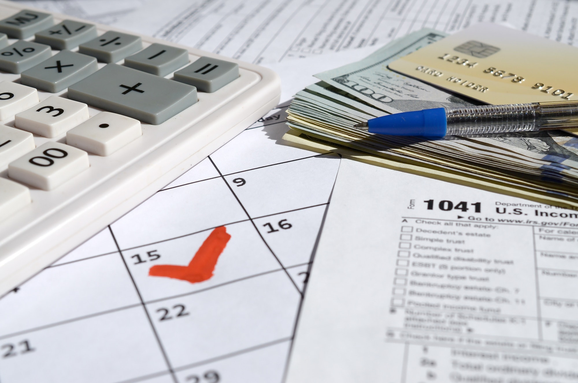 1041 Income Tax Return for Estates and Trusts blank with dollar bills