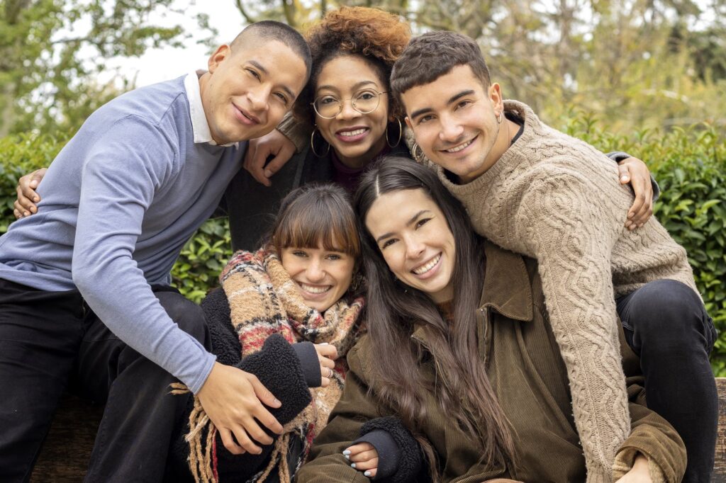 Five Friends Discussing Wills On Park Bench Resized